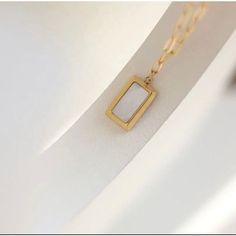 Delicate and understated, this Square Mother of Pearl Pendant Necklace will add a touch of elegance to any outfit. The 18k gold plating and stainless steel construction mean it's durable enough for everyday wear, while the mother-of-pearl pendant provides just the right amount of sparkle. Dainty Pearl Necklace, Real Pearl Necklace, Stacked Necklaces, 18k Gold Necklace, Hypoallergenic Jewelry, Square Pendant, Real Pearls, Pearl Pendant Necklace, Shell Pendant