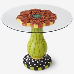 a glass table with a flower painted on it