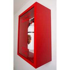 a red fire extinguisher hanging on the wall