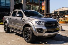 a silver truck parked in front of a building