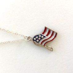 Beautiful red and blue enameled American flag charm with rhinestone stars hangs on delicate sterling silver necklace. One-sided wavy American flag is 24 x 17mm USA made high quality pewter with tiny sparkling rhinestone crystal stars. Flag hangs from delicate .925 sterling silver cable chain with spring ring clasp. Matching bracelet and earrings also available in my shop. This listing is for one USA flag necklace only. Patriotic Nickel-free Jewelry For 4th Of July, Silver Jewelry For 4th Of July Gift, Silver Jewelry Gift For 4th Of July, Red American Flag Jewelry For Independence Day, Red Jewelry For 4th Of July Gift, Patriotic American Flag Jewelry Gift, American Flag Jewelry For 4th Of July Gift, American Flag Jewelry For 4th Of July, American Flag Jewelry Gift For 4th Of July