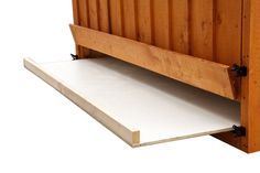 a person holding a piece of paper in front of a wooden bed headboard and foot board