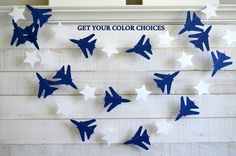 blue and white paper airplanes are hanging on the wall with words get your color choices