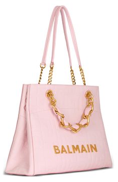 The soft pink leather of this spacious shopper makes the galvanized, golden hardware and chain straps pop in contrast. Olivier Rousteing's 1945 collection highlights the bold optimism behind the house's founding with bags inspired by some of Pierre Balmain’s strongest midcentury designs. Magnetic-snap closure Top carry handles; shoulder straps Snap gussets Interior zip pocket; card slot Lined Leather Made in Italy Designer Handbags Soft Leather Tote, Pocket Card, Pierre Balmain, Embossed Logo, Pink Leather, Pink Bag, Leather Tote Bag, Metal Chain, Chain Strap