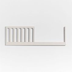 a white wall mounted shelf with a metal bar on the top and bottom, against a white background