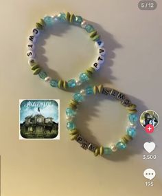 two bracelets with charms on them sitting next to each other and an image of a building