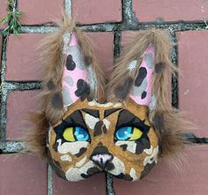 Looking for the perfect cat mask to complete your Therian or quadrobics look? Look no further than our handmade cat mask! Perfect for quadrobics, cosplay, anime, and Halloween costumes. Each mask is 100% handmade with high-quality felt, paint, fur, and foam. It takes 4 hours to create each mask, ensuring attention to detail and durability. With a one-size-fits-most design, this mask is sure to be a hit with therians and quadrobists of all ages. Cat Ears Masks With Whiskers For Masquerade, Masquerade Cat Ears Mask With Whiskers, Halloween Cosplay Cat Design Mask, Cat Design Eye Mask For Cosplay, Cosplay Cat Design Eye Mask, Cosplay Cat Design Mask, Brown Spotted Cat, Therian Gear, Felt Animal Masks