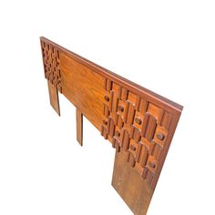 a wooden table with intricate carvings on the top and bottom part, against a white background