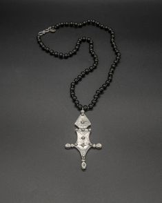 This unique pendant captures the essence of the traditional Tuareg design. Nomads of the desert, the Tuareg inhabit a vast territory spanning from the Moroccan Saharan desert to Burkina Faso in the south. This silver Nigerian Tuareg Bagzan Cross is paired with a hand-knotted tourmaline chain. The tourmaline chain is 57 cm long [22.5 in long] Moroccan Necklace, Tuareg Jewelry, Unique Pendant, The Desert, Healing Stones, The South, Handcrafted Jewelry, Tourmaline, Hand Knotted