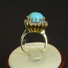 Pretty Levian Sleeping Beauty Turquoise diamond ring, This cabochon is cut in a cute teardrop shape and has a halo of round brilliant diamonds. Ring Size: 7 Total Weight: 8.31 grams Precious Metal: 14k yellow gold Precious stones: -Sleeping Beauty Turquoise Center Stone: 17mmx11.5mm, 13.8 carats -White Round Diamonds: 0.63 carats Hallmark: Levian, 14k Fine Jewelry Turquoise Diamond Ring, Luxury Turquoise Diamond Ring With Center Stone, Gold Diamond Turquoise Ring, Formal Fine Jewelry Turquoise Diamond Ring, Formal Turquoise Diamond Ring With Gemstone, Oval Diamond Turquoise Ring For Formal Occasions, Oval Turquoise Ring In Yellow Gold With Diamond, Formal Oval Turquoise Ring With Diamond, Anniversary Turquoise Ring With Diamond Accents