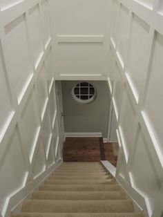 the stairs lead up to an air vent on top of carpeted steps in front of a white wall