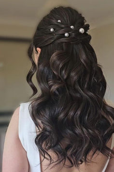 Romantic cascading chocolate curls adorned with elegant pearl accents in a volumized half-up, half-down hairstyle exuding drama and charm, ideal for special occasions. // Photo Credit: Instagram @d__hairstylist Prom Pearl Hairstyles, Half Up Half Down Hair With Accessories, Bridesmaid Hairstyles Half Up Half Down Dark Hair, Pearly Hairstyle, Prom Night Hairstyle Soft Curls, Wedding Hairstyles Half Up Half Down Medium Length Dark Hair, Half Up Half Down Pearl Hair, Half Up Half Down Pearls, Hairstyles Formal Elegant Down