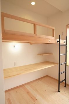 an empty room with wooden shelves and ladder