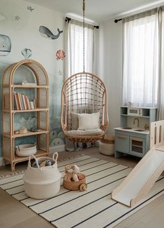 a child's room with a swing chair, bookshelf and play area