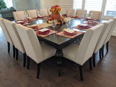 a dining room table is set with place settings and place settings for the dinner guests