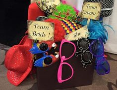 a box filled with hats, sunglasses and signs that say team bride to be on it