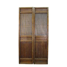 two wooden doors with woven screens on them