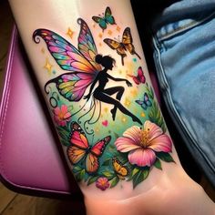 a woman's arm with a colorful tattoo on it and butterflies flying around her