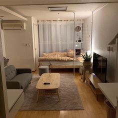 a living room filled with furniture and a flat screen tv sitting on top of a hard wood floor