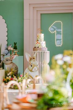 a table topped with lots of cakes and bunnies