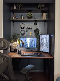 a computer desk with a monitor, keyboard and mouse on it in front of a wall mounted clock