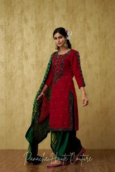 Introducing our Stunning Dark Emerald Green and Red Punjabi Suit Set, a mesmerizing outfit that will leave everyone awestruck. The kameez is made of luxurious red velvet, which gives it a regal and rich look. The dark emerald green embroidery on the kameez adds a touch of elegance and sophistication to the overall design. The salwar is made of plain silk in a green color that complements the kameez beautifully. The green monotone embroidery on the salwar adds a subtle yet stylish touch to the ou Red Punjabi Suit, Monotone Embroidery, Dark Emerald Green, Curated Outfit, Green Embroidery, Timeless Outfits, Indian Wedding Wear, Green Square, Green Suit