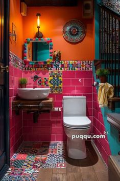 a bathroom with pink and orange tiles on the walls, toilet and sink in it