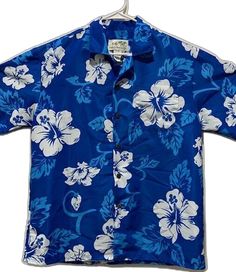 Blue Long Sleeve Hawaiian Shirt, Blue Hawaiian Shirt For The Beach, Blue Hawaiian Button-up Shirt, Blue Hawaiian Top With Button Closure, Blue Short Sleeve Hawaiian Shirt With Button Closure, Blue Cotton Hawaiian Shirt With Buttons, Classic Blue Button-up Camp Shirt, Blue Collared Hawaiian Shirt With Button Closure, Classic Blue Tops For Beach