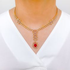 Make a statement with this Intricate Floral Ruby Diamond Set. Crafted from 18k yellow gold, this set features sparkling diamonds with a total weight of 8.34 carats, and exquisite pear-shaped rubies. The interchangeable stones allow for versatility, while the 16.75" set length and 2.25" drop length provide a striking look. Matching screw-back earrings complete the set. PRODUCT DETAILS Gold Purity(karat): 18k Item Weight(grams): 62.8 Item Finish: Yellow Gold Stone: Diamond Diamond Weight(carats): Formal 22k Gold Red Jewelry, Formal Red 22k Gold Jewelry, Luxury Ruby Bridal Necklace, Luxury Ruby Diamond Necklace With Diamond Accents, Luxury Ruby Diamond Necklace With Accents, Luxury Hand Set Ruby Jewelry Sets, Formal Red Diamond Necklace With 17 Jewels, Elegant 22k Gold Bridal Necklace With Gemstones, Formal Bridal Necklace In Yellow Gold With Gemstone