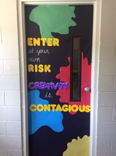 a door decorated with colorful paint and words