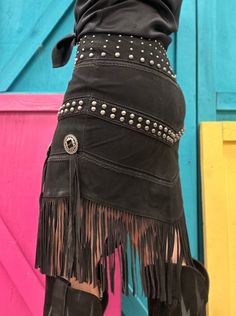 This Scully skirt features genuine leather, studs at the waist and hipline, concho accents along with fringe on the v-shaped hem. This classic western styled skirt will make a fresh, fun addition to any wardrobe. Great paired with your favorite boots! Genuine lamb suede leather Polyester lining Zipper Back V Hemline Studs at the waistband and hipline Concho accents Long fringe accents Approximate waist size: S = 30 " M = 32" L = 33" XL = 34" Crochet Lace Skirt, Suede Fringe Skirt, Beige Crochet, Long Fringe, Favorite Boots, Fringe Skirt, Western Hats, Western Leather, Suede Fringe