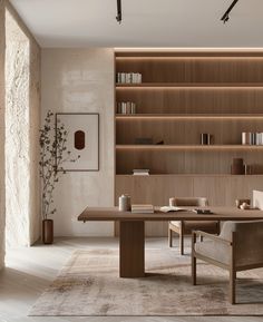 a dining room table and chairs with bookshelves in the background