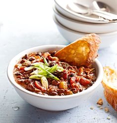 a bowl of chili with bread on the side