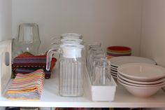 the shelves are filled with dishes and glassware