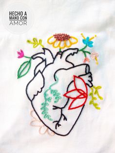 an embroidered heart with flowers and butterflies in it on a white t - shirt that says hello madison armor