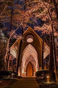 a church lit up at night in the woods