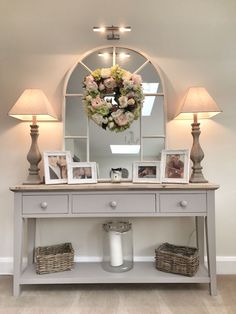 a white table topped with a mirror and two lamps