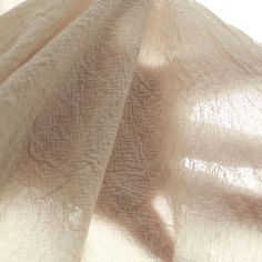 the fabric is very soft and white with some light coming through it's folds