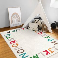 a child's room with a teepee tent and toys on the floor