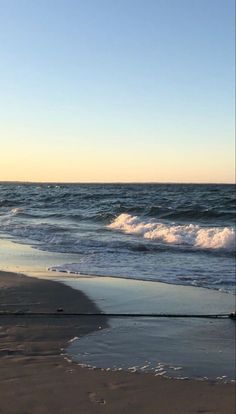 an ocean beach with waves coming in to shore