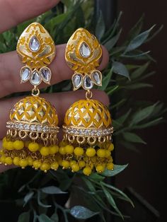 Gorgeous  Pastels Jhumkas  with pearl. Each piece is handcrafted . All the raw material used in this product is of high quality and is handcrafted with love. Trendy Earring Indo Western Earring 100% Satisfaction Guarantee: Long Lasting Plating, High-Quality Stones. Gifting: This pair of earrings come in a beautiful gift pack , making it an ideal gift for birthday, wedding anniversary or wedding gift. Occasion: Perfect choice for any Indian occasion. Care: It is advisable that you keep our produc Traditional Yellow Dual-tone Jewelry, Festive Yellow Meenakari Jewelry, Traditional Yellow Cutdana Jewelry, Festive Yellow Meenakari Jhumkas, Eid Gold Meenakari Jhumkas, Festive Yellow Chandbali Jewelry, Yellow Temple Jewelry Earrings For Festivals, Festive Yellow Cutdana Jewelry, Yellow Kundan Chandbali Earrings