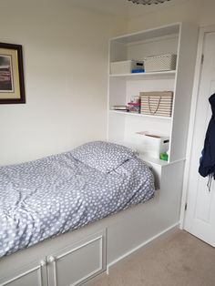 a bedroom with a bed, closet and bookshelf