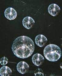 many disco balls are hanging from the ceiling