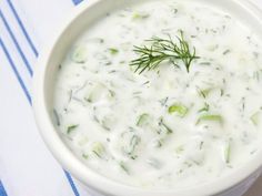 a white bowl filled with sour cream and vegetables