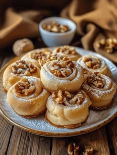 several cinnamon rolls on a plate with walnuts