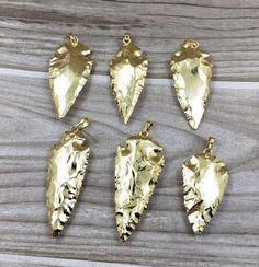 Listing is for ONE (1) of these full gold plated Arrowheads arrowhead pendant (S8_B47)  These are lovely arrowheads  Average measure of arrowheads is approximately 23-27mm x 45-60mm, but measurements will vary  Wonderful piece that is sure to stand out.  Available for bulk wholesale convo me for pricing information Gold Arrowhead Jewelry Gift, Gold Arrowhead Jewelry For Gift, Gold Arrowhead Necklace Gift, Gold Arrowhead Necklace As A Gift, Gold Arrowhead Necklace For Gift, Rock Crystal, Quartz Crystal, Charm Necklace, Gold Plate