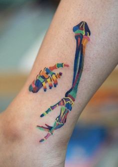 a colorful tattoo on the leg of a woman