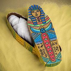 two wooden shoes with painted designs on them