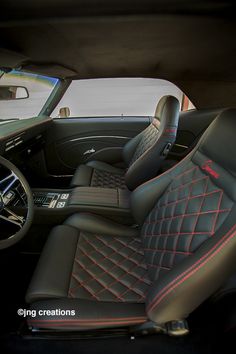 the interior of a car with black leather and red stitching