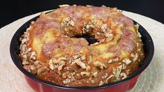 a bundt cake sitting in a red pan on top of a white table cloth